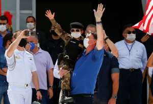 Brazilian President Jair Bolsonaro (C) has ignored social distancing practices and criticised the need for a lockdown. By Sergio LIMA (AFP)
