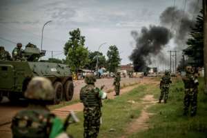Burundian peacekeepers of the African-led International Support Mission to the Central African Republic (MISCA) patrol near a barricade of burning tyres in the Bea-Rex district of Bangui. By MARCO LONGARI (AFP/File)
