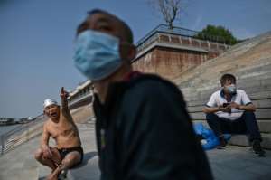 But in a sign of what lies ahead, the gradual awakening of Wuhan, the Chinese city where the virus first emerged, remains tinged with fear. By Hector RETAMAL (AFP)
