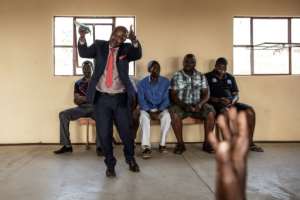 Candidate Michael Musuku addressed 30 voters at a community hall, vowing to use the entrepreneurial skills developed running his restaurant to help voters. 