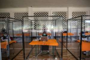 Candidates for Indonesian civil servant jobs sit an exam inside a plastic chamber after they tested positive for COVID-19. By JUNI KRISWANTO (AFP)