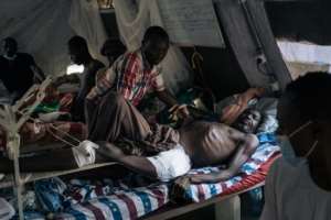 Casualty: A man wounded in one of the attacks in the Beni area is treated in a Red Cross hospital. By ALEXIS HUGUET (AFP/File)