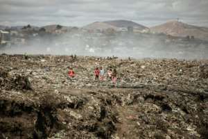Children and waste pickers sift through garbage at a landfill near 'Cite Akamasoa' - 'Akamasoa Town'. By GIANLUIGI GUERCIA (AFP)
