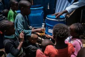 Children in the notorious Nairobia slum of Kibera learn how to wash hands to help prevent coronavirus. By Yasuyoshi CHIBA (AFP)