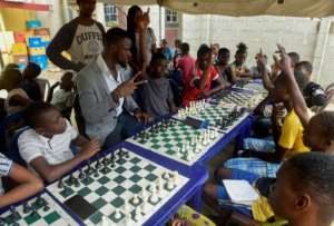 Children play their chess games in a makeshift tent in the courtyard of a local bar in the impoverished neighbourhood of Ikorodu, Lagos. By PIUS UTOMI EKPEI (AFP)
