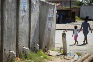 Communal toilets in the informal settlement often overflow, spilling human waste onto the street. By RODGER BOSCH (AFP)