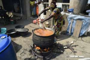 Cooks in masks prepared food for dancers and guests during the Slum party. By PIUS UTOMI EKPEI (AFP)