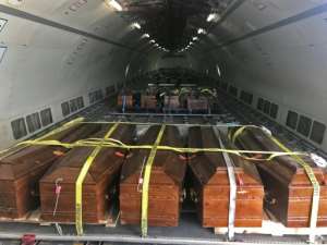 Coffins containing the remains of 20 Egyptian Coptic Christians beheaded by jihadists on the beach in Sirte in 2015 are loaded onto a plane in Misrata on May 14, 2018, before being sent to Cairo. By MAHMUD TURKIA (AFP)