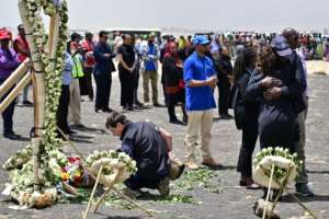 Colleagues of victims of the UN's World Food Programme office in Addis Ababa hugged in grief as they visited the crash site. The UN lost 22 staffers on the flight. By TONY KARUMBA (AFP)