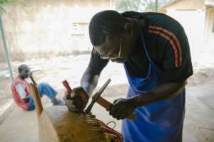 Cowhide is strung across the gourd to form the kora's soundbox. By CARMEN ABD ALI (AFP)