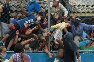 Crowds rush to receive free hens given out by a Honduran presidential pre-candidate in El Carrizal, in Tegucigalpa. By ORLANDO SIERRA (AFP)