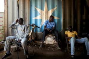 Customers wait to have their Vespa repaired. The Italian scooter has long been supplanted in Mali by a cheaper, Indonesian-made machine, but its vintage looks are prized by many. By MICHELE CATTANI (AFP)