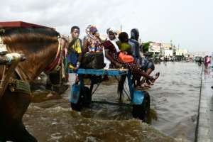 Dakar regularly floods during the July-October rainy reason, but the problem is getting worse. By SEYLLOU (AFP)