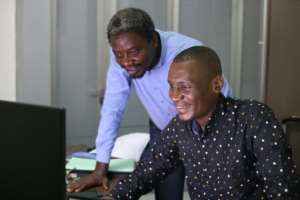 Dechagrains Ebeh, right, at his office in Pointe-Noire. By SAMIR TOUNSI (AFP)