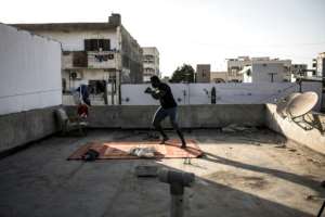 Diop trains with shadow fighting as he worries about takes precautions against an invisible foe. By JOHN WESSELS (AFP)