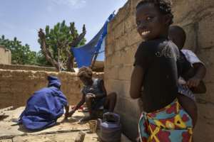 Displaced children play in the court of a house in Segou, central Mali, where their families seek refuge from violence. By MICHELE CATTANI (AFP/File)