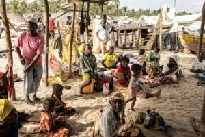 Displaced people arrive at Paquitequete beach in Pemba after fleeing Palma. By JOHN WESSELS (AFP)