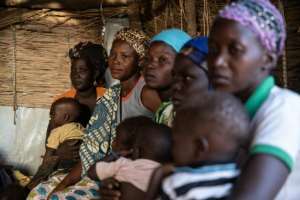 Displaced women and children in Kaya, northern Burkina Faso. Overcrowding in the camps makes social distancing a huge challenge, say aid workers. By OLYMPIA DE MAISMONT (AFP)