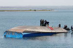 Divers continued their grim search in the waters around the upturned hull, watched by anxious crowds gathered just metres away on Ukara's shore. By STRINGER (AFP)