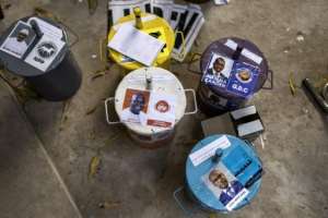 Each candidate has their own ballot box at Gambian polls, and voters choose their preferred politician by dropping a marble inside one of the boxes. By JOHN WESSELS (AFP)
