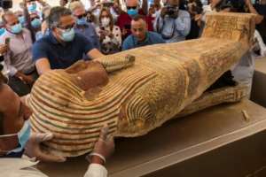 Egypt continues to unearth ancient remains - - this photograph from October 2020 shows the opening of a sarcophagus excavated by the Egyptian archaeological mission at the Saqqara necropolis near Cairo. By Khaled DESOUKI (AFP)