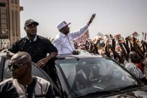 Eddie Komboigo, standing for the party of former president Blaise Compaore, hails the crowd at a rally in Ouagadougou. By OLYMPIA DE MAISMONT (AFP)