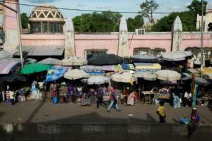 Eight days after the coup that deposed President Ibrahim Boubacar Keita, the capital's grand market is busy as usual. By ANNIE RISEMBERG (AFP)