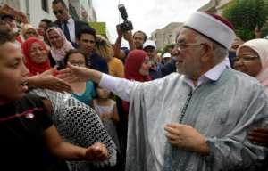 Ennahdha's presidential candidate Abdelfattah Mourou speaks with supporters in the Tunisian capital ahead of the September 15 polls. By FETHI BELAID (AFP)