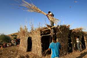 Ethiopian refugees build a house in the Um Raquba camp in Sudan, some of the more than 36,000 Ethiopians who have fled fighting in the northern Tigray region. By ASHRAF SHAZLY (AFP)