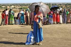 Ethiopian refugees who fled the fighting in the Tigray region gather on the banks of a border river with Sudan, in the Hamdayit area of Sudan's eastern Kassala state, on November 22. By ASHRAF SHAZLY (AFP/File)