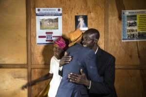 The Tutsi ethnic group Jean-Bosco Gakwenzire (hat), 65, kisses Pascal Shyirahwamaboko, 68, who murdered his father in Mutete, where former clbadmates reconciled. By JACQUES NKINZINGABO (AFP / File)