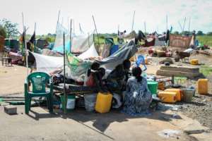 Families set up makeshift camps along a highway, grabbing what few possessions they could from the wreckage of their homes. By Peter Louis GUME (AFP)