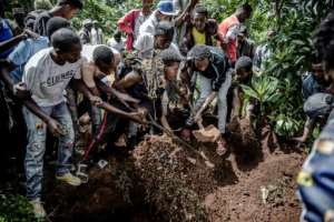 Family and friends bury a 13-year-old boy allegedly killed by police in Nairobi, enforcing the dusk-to-dawn curfew imposed by the Kenyan government. By LUIS TATO (AFP)