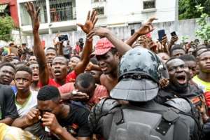 Fans cried and chanted outside the hospital where Ivorian singer DJ Arafat died after a traffic accident. By ISSOUF SANOGO (AFP)