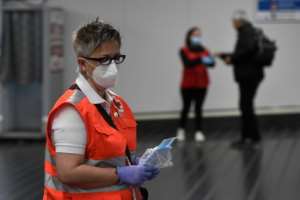 Face masks were handed out at a train station in Madrid Monday as lockdown restrictions were slightly eased. By PIERRE-PHILIPPE MARCOU (AFP)