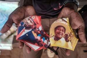 Face time: Masks with pictures of the two frontrunners. By SUMY SADURNI (AFP)