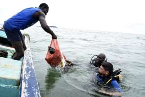 Farewell, rubbish: Scuba divers bring up plastic waste and other items collected from a bay off Dakar. By SEYLLOU (AFP)