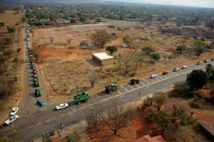 Farmers on the vehicles driving to the protest. By Phill Magakoe (AFP)