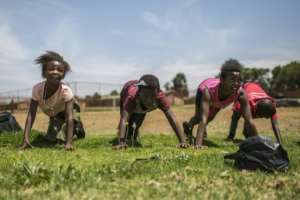 Female players from the Soweto Rugby Schools Academy train hard. By Guillem Sartorio (AFP)