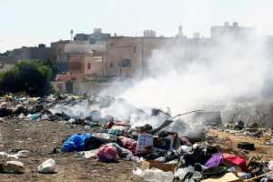 Fed up by the smell and the sight of rats and stray cats feasting in the garbage, some Tripoli residents have taken to burning the rubbish. By Mahmud TURKIA (AFP)