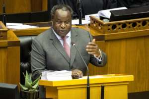 Finance Minister Tito Mboweni, pictured delivering the 2020 budget speech, has said attempts to cut state-sector waste are like getting teeth extracted without anaesthetic. By RODGER BOSCH (AFP)