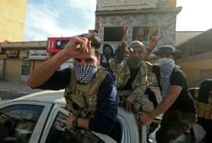 Fighters loyal to the GNA celebrate on April 13, 2020 after seizing the coastal city of Sabratha from Haftar's forces. By Mahmud TURKIA (AFP/File)