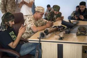 Fighters loyal to the nationally recognized accord government around the world gather around a table and embark on the online video game PlayerUnknown's Battlegrounds (PUBG). By FADEL SENNA (AFP)