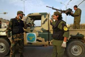 Fighters of a military battalion loyal to Haftar patrol the streets in the eastern city of Benghazi during a state of emergency to combat the coronavirus. By Abdullah DOMA (AFP/File)