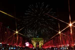 Fireworks erupt over the Arc de Triomphe during the New Year's celebrations on Champs Elysees avenue, where tens of thousands gathered despite a grueling transport strike. By Martin BUREAU (AFP)