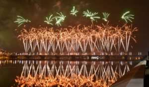 Fireworks light up the sky over the General de Gaulle bridge and the Ebrie lagoon during New Year's celebrations in Abidjan, Ivory Coast. By SIA KAMBOU (AFP)