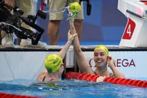 First-placed Australia's Emma McKeon (R) celebrates with third-placed Australia's Cate Campbell after winning the final of the women's 100m freestyle swimming event. By Oli SCARFF (AFP)