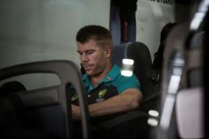 Former vice-captain David Warner of the Australian Cricket Team sits in the shuttle bus as he arrives at OR Tambo International Airport after the team was caught cheating in the Sunfoil Test Series between between Australia and South Africa on March 27, 2018.