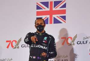 Formula One world champion Lewis Hamilton -- seen here celebrating his victory in Bahrain -- has tested positive for the virus. By Giuseppe CACACE (POOL/AFP)