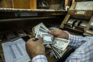 Four years since Egypt devalued its currency and took unpopular austerity measure the economy has seen a steady growth but many Egyptians are struggling to make ends meet. By KHALED DESOUKI (AFP/File)